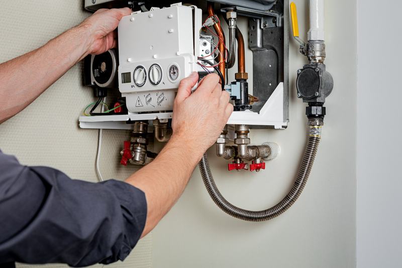 A gas engineer fixing a boiler